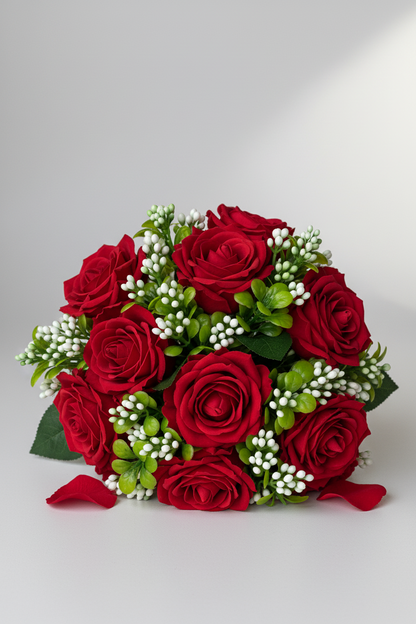 Artificial white berry and foliage stems styled in a classic red rose bouquet with white gypsophila and green foliage on a light grey background
